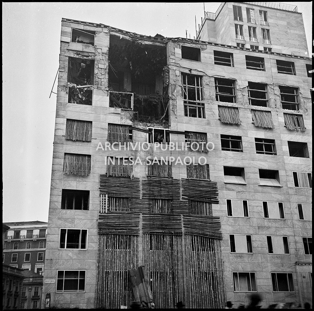 Palazzo Montecatini, in via della Moscova a Milano, gravemente danneggiato dai bombardamenti e con alcune opere di messa in sicurezza già apprestate. In strada si vede il pilastro pericolante fatto crollare