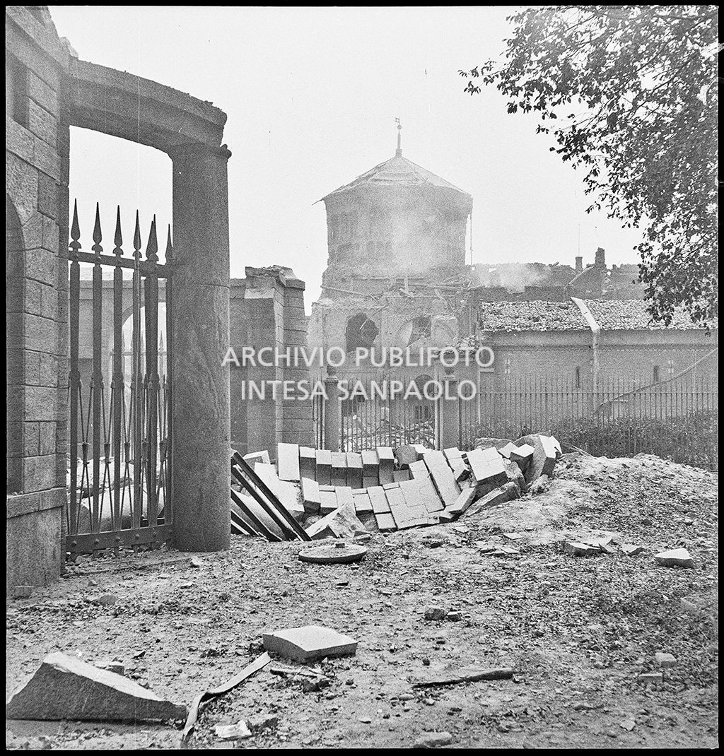Scorcio della basilica di Sant'Ambrogio a Milano danneggiata dai bombardamenti; sulla sinistra il recinto che circonda il Monumento ai Caduti