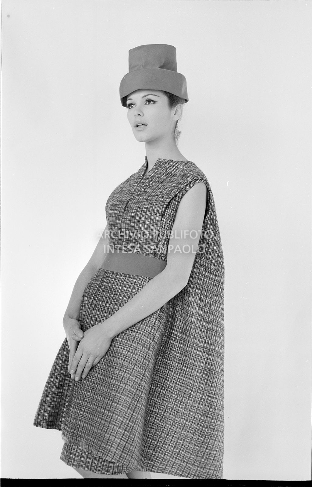 Indossatrice con abito ampio a quadri e cappello<br>10908