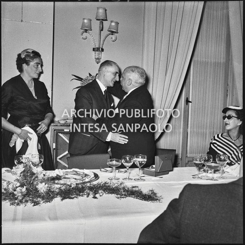 Due uomini si abbracciano in occasione del banchetto della SAER al ristorante Tantalo di Milano<br>196129