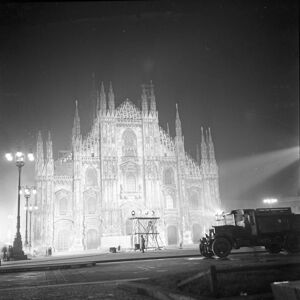 Ripresa notturna di piazza del Duomo a Milano con la cattedrale illuminata dai riflettori del set del film "Miracolo a Milano"