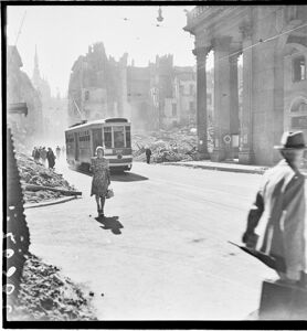 Le macerie sono state addossate ai lati della strada per consentire la circolazione. Il tram ha le fasce bianche per renderlo più visibile durante l'oscuramento